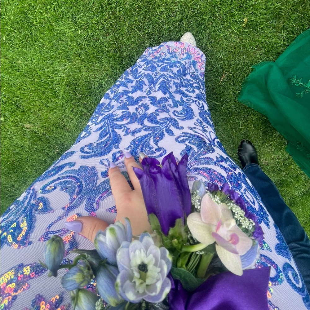 A purple prom dress with blue and purple sequins.